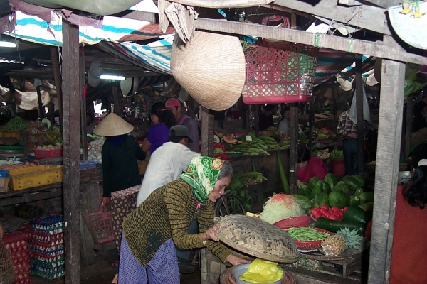 An old woman checks the merchandise